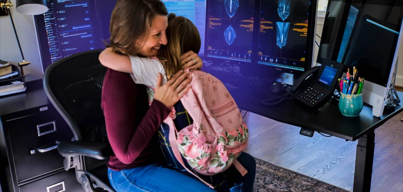 remote radiologist happy hugging daughter